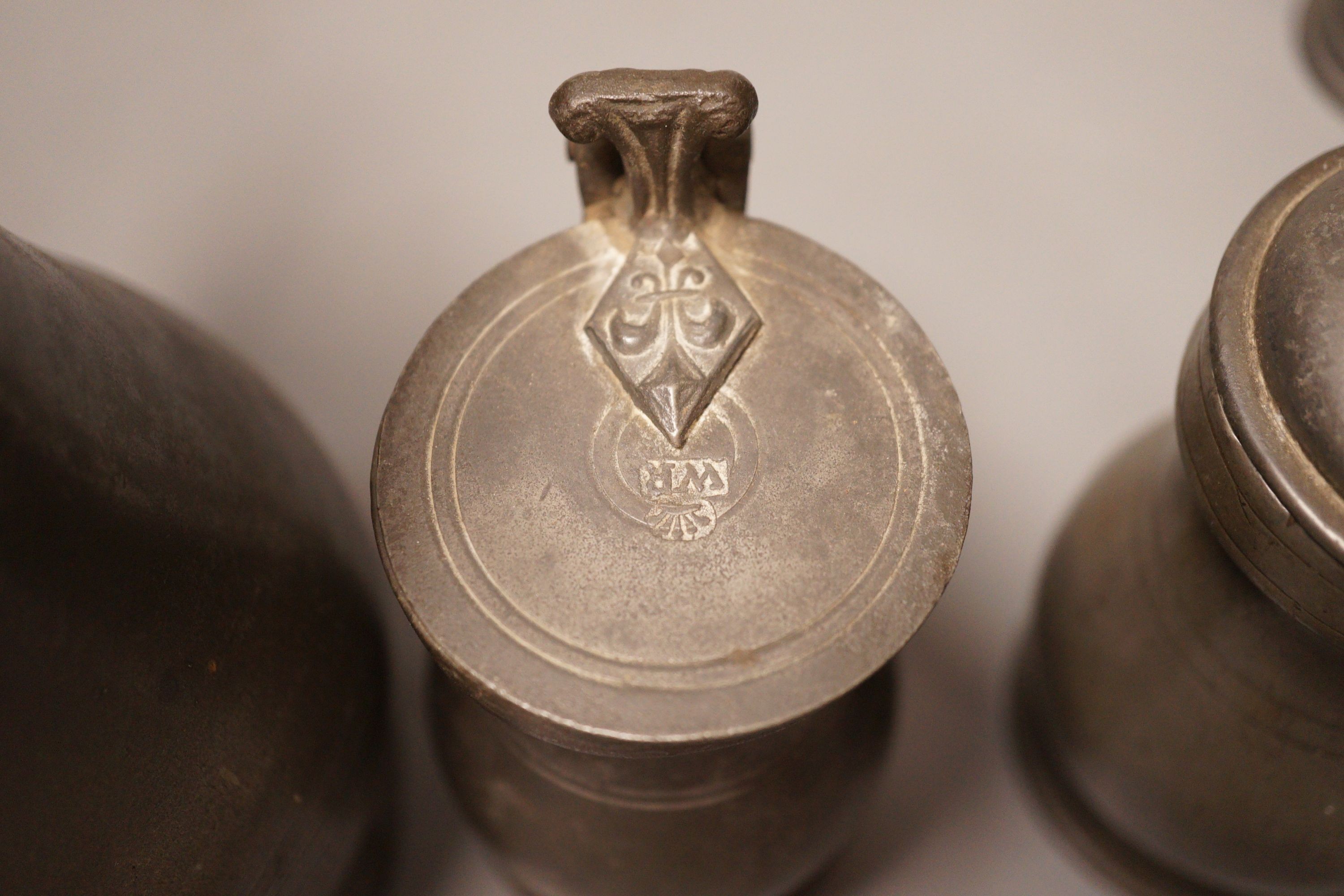 A group of 18th / 19th century pewter measures, 19cm